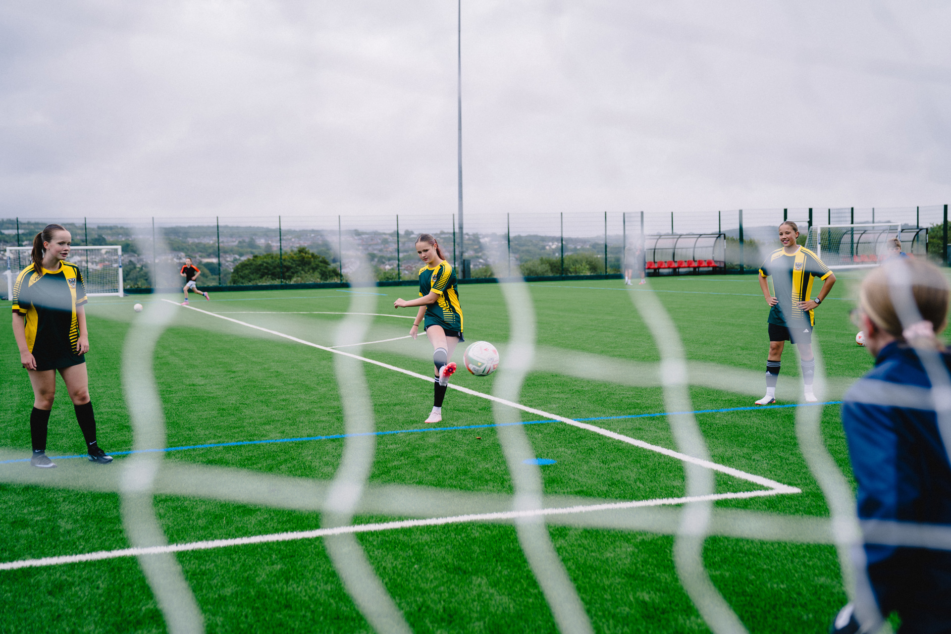 An image of children playing football on the pitch.