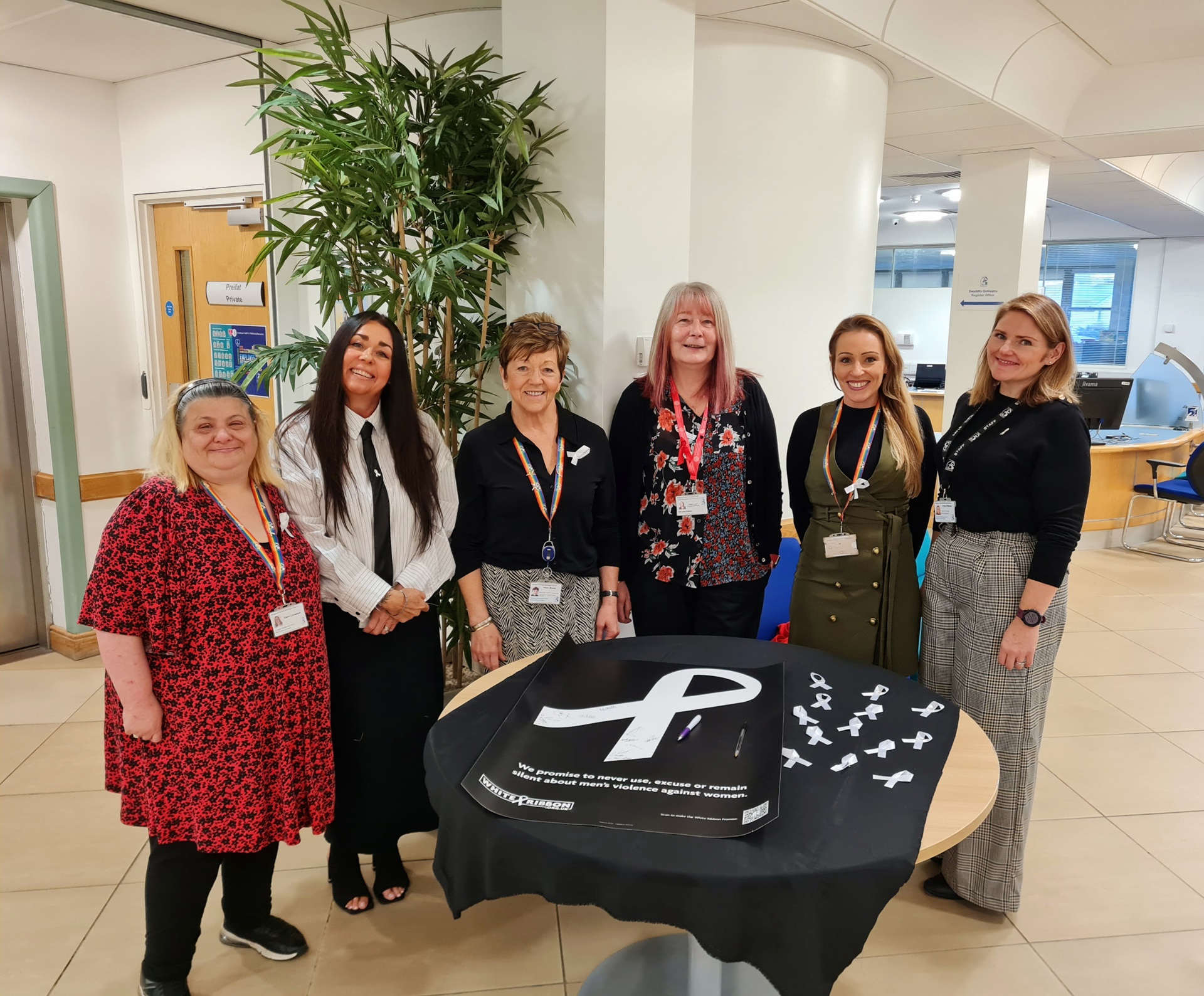 (l to r): Dawn Llewellyn, Customers Services (BCBC), Kimberley Coles and Helen Moses, Assia DAS, Deputy Leader, Councillor Jane Gebbie, Zoe Edwards, Consultation Engagement and Equalities Manager (BCBC) and Kirsty Williams, Partnership and Community Safety Partnership Manager (BCBC) encouraging people to sign the White Ribbon pledge to #changethestory.