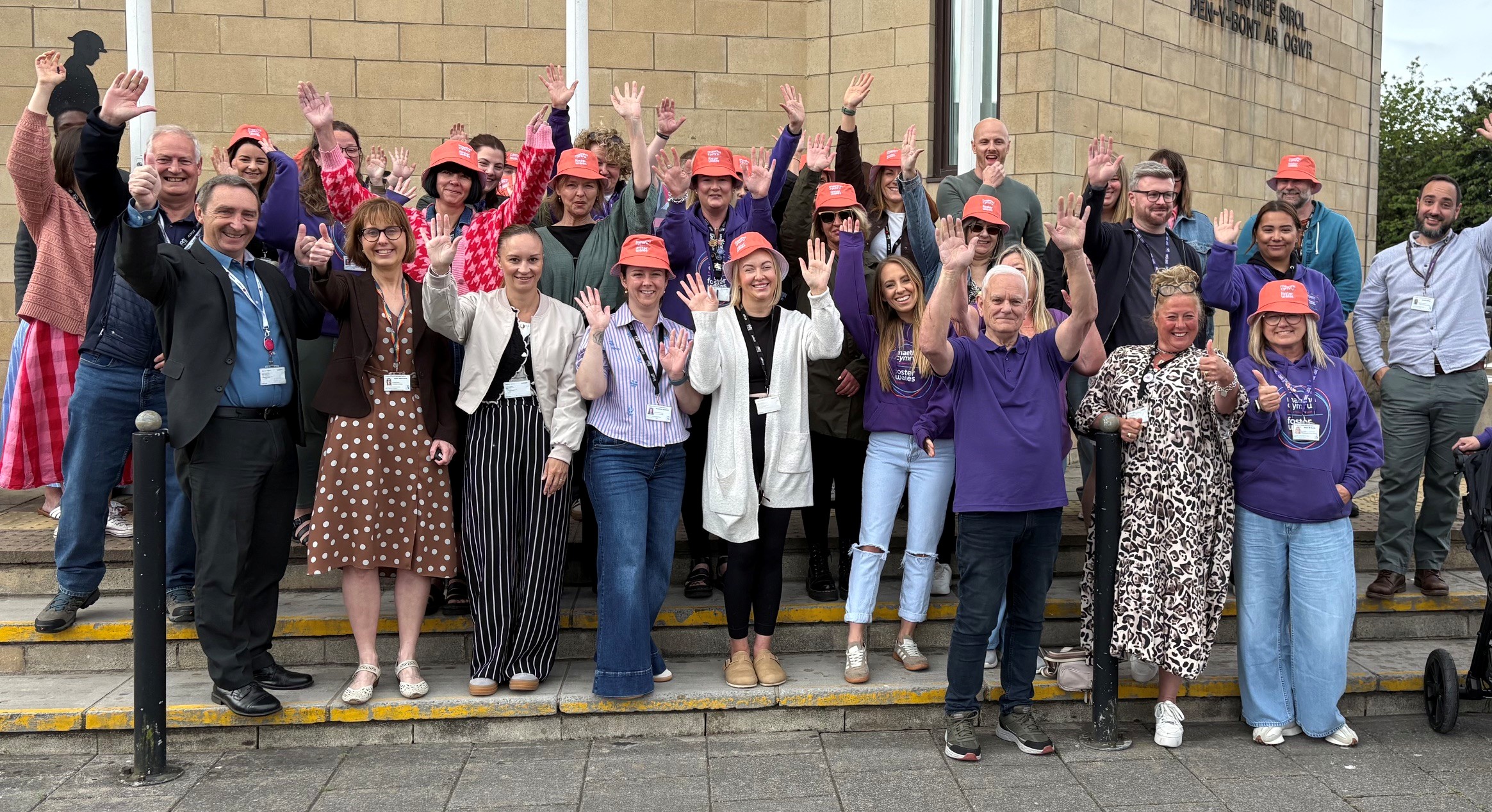 Bridgend Foster Carers raising the flag at Civic Offices to mark the start of Foster Care Fortnight.