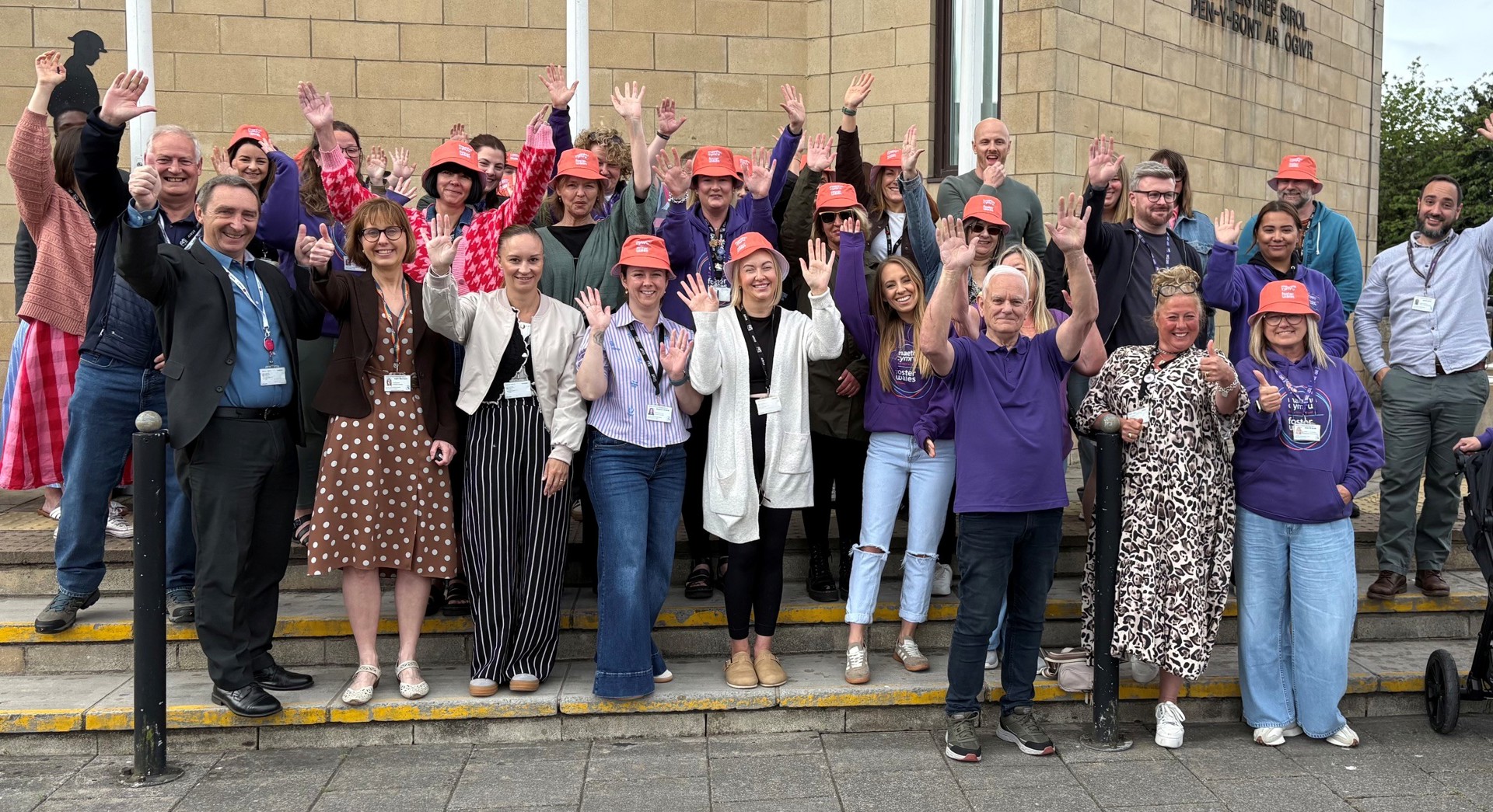 Bridgend Foster Carers raising the flag at Civic Offices to mark the start of Foster Care Fortnight.