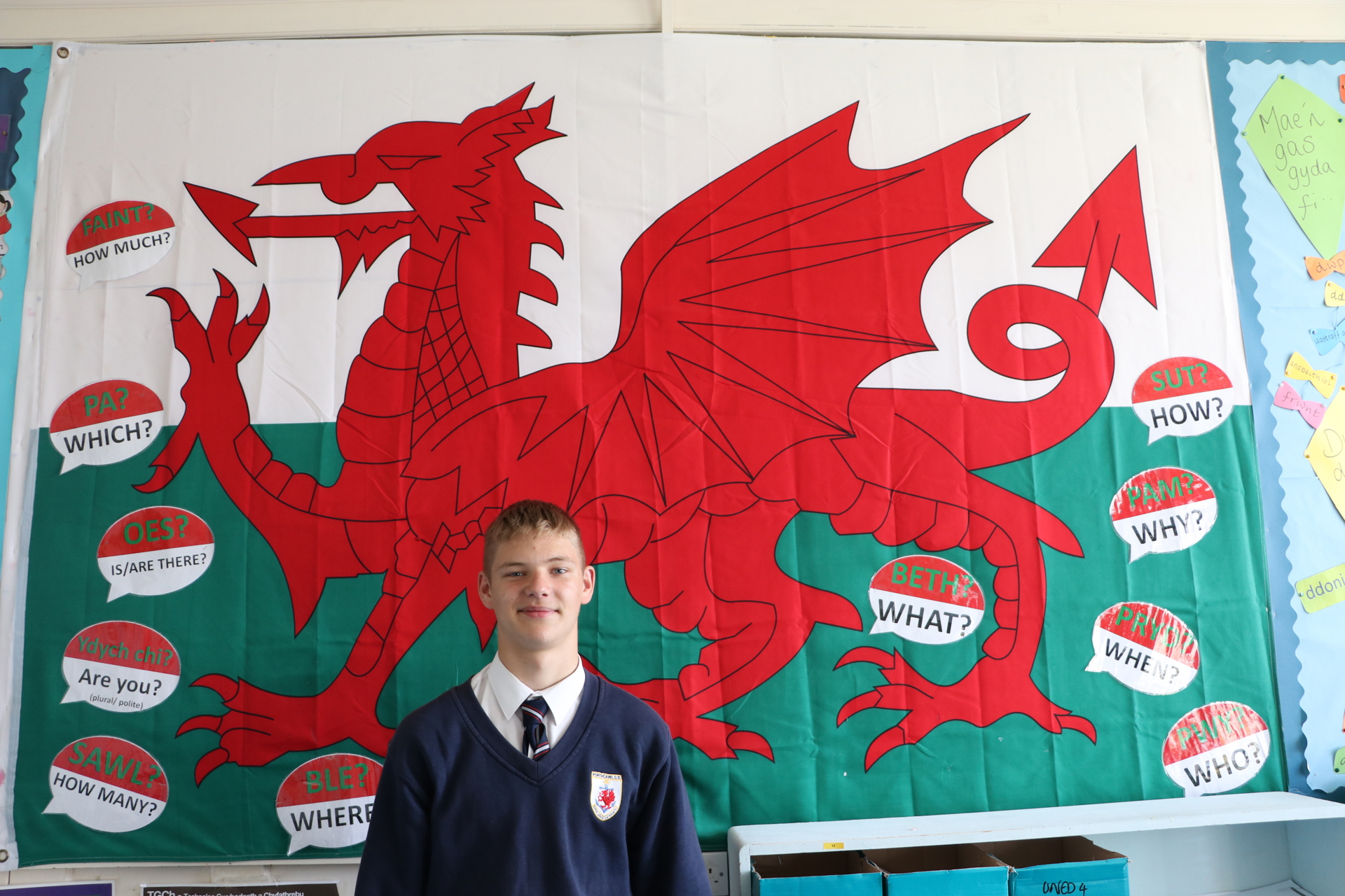 Ukrainian porthcawl pupil in front of a Welsh flag.