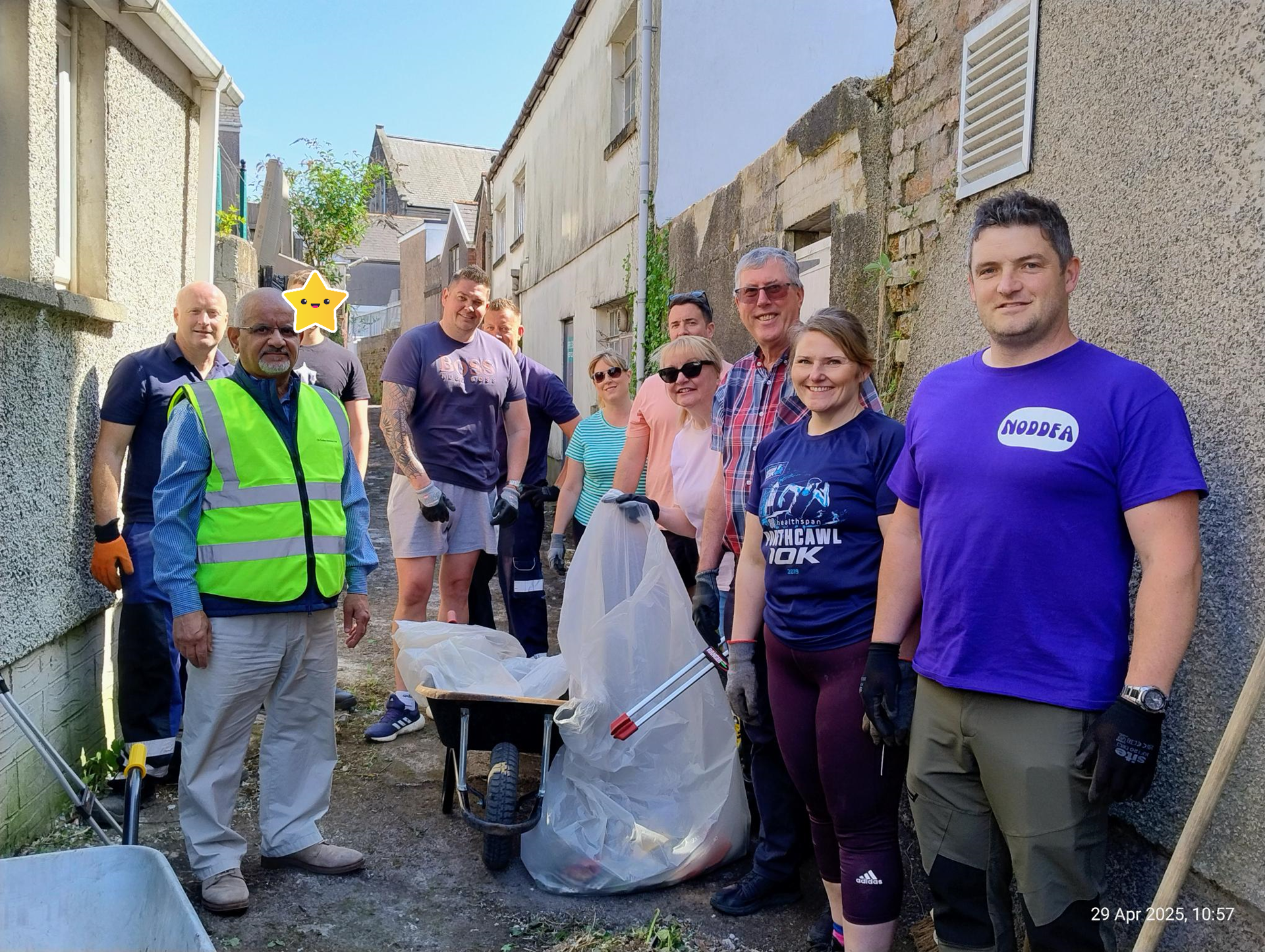 The team involved in the lane clearance; the excavator provided by Hoopers Agriculture Plant Services, and the skip full of rubbish from the lane.