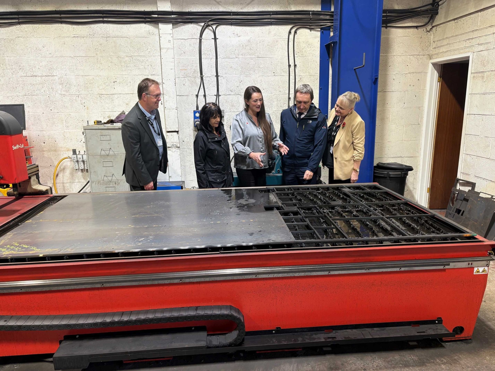 Council Leader, Cllr John Spanswick and Cabinet Member Cllr Neelo Farr pictured with members of the Economy and Enterprise team and owner Laura Healey.