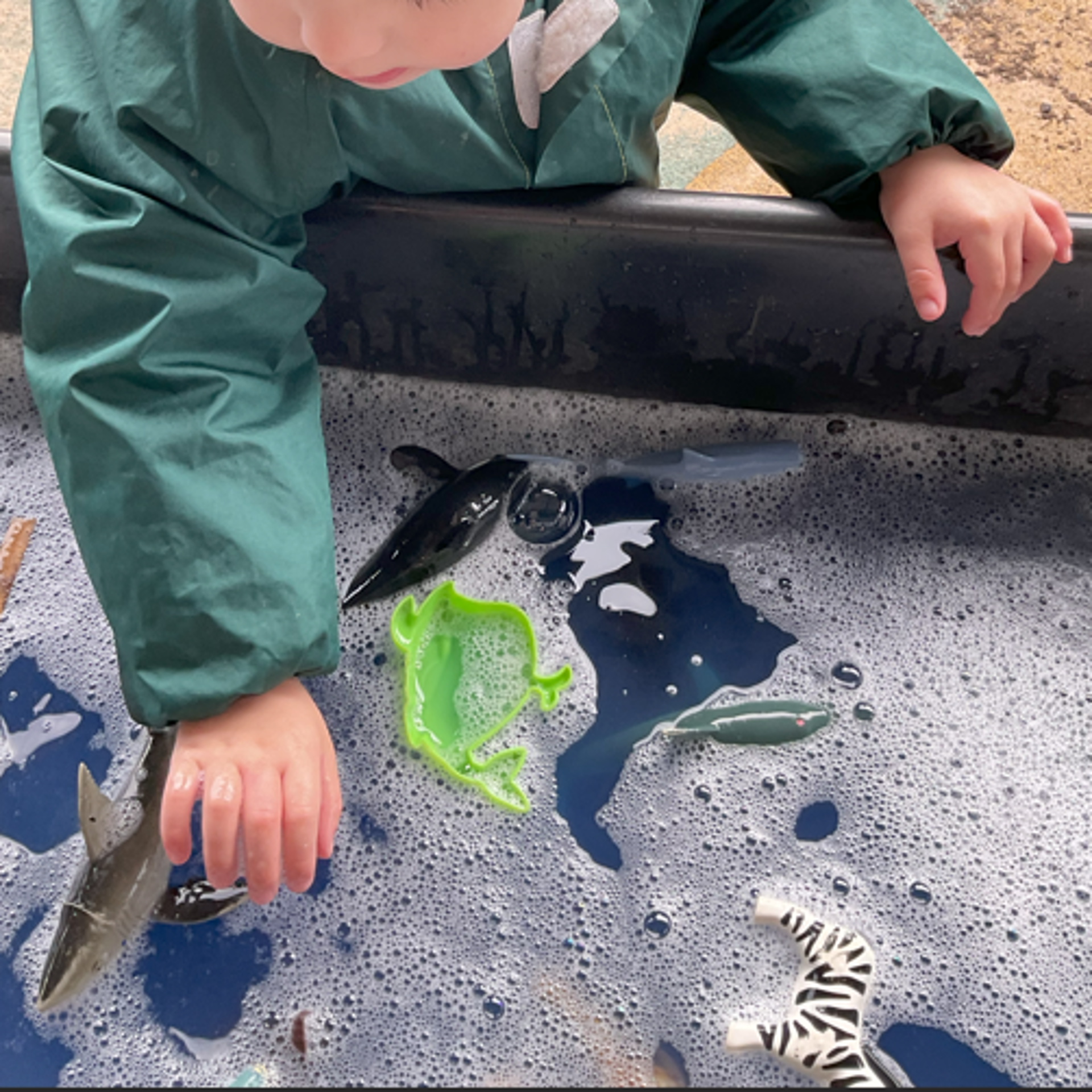Child playing with water and toys