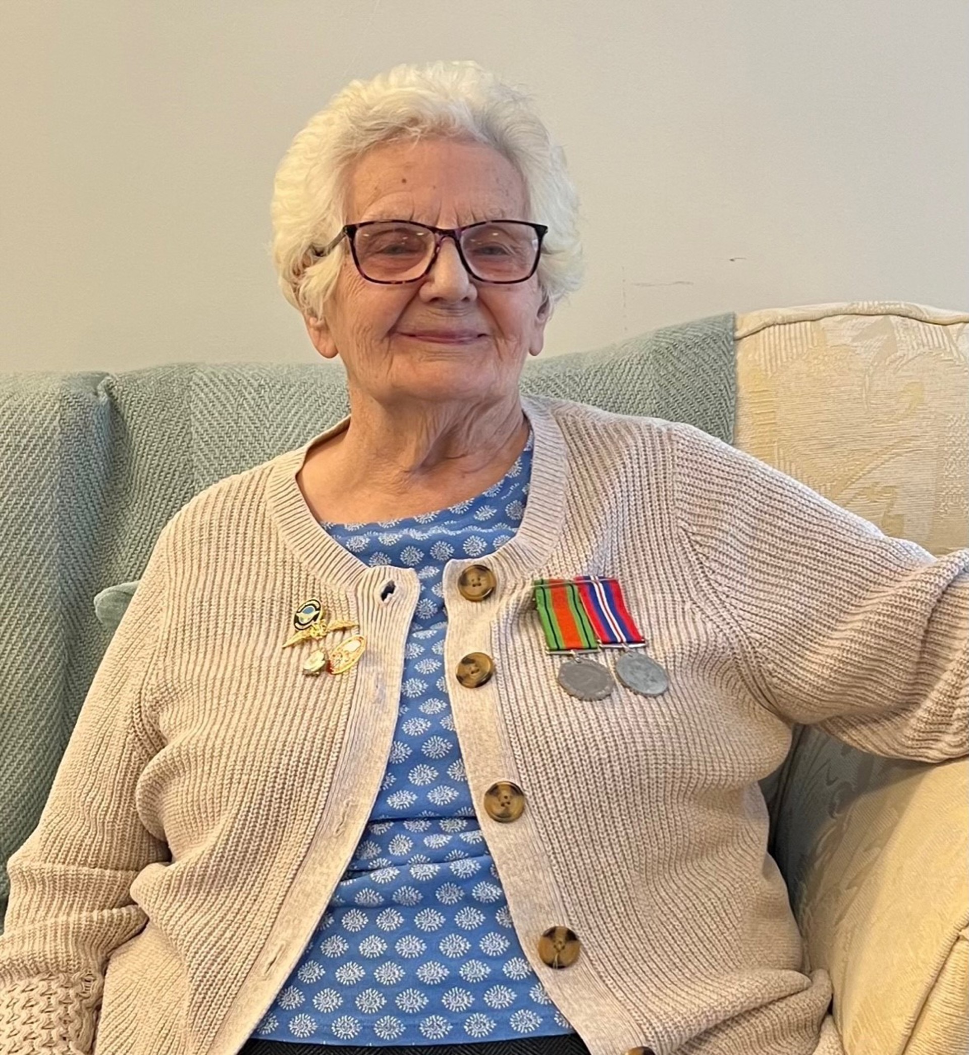 Margaret Rees wearing her medals at Ty Cwm Ogwr