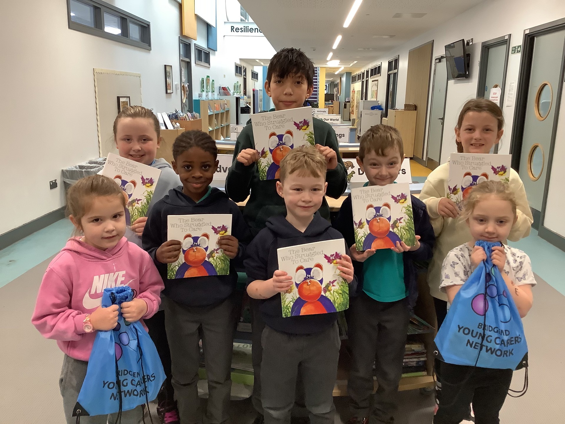 Pupils from Pencoed Primary pose with their copies of ‘The Bear Who Struggled To Care’, a children’s book written by local young carers.